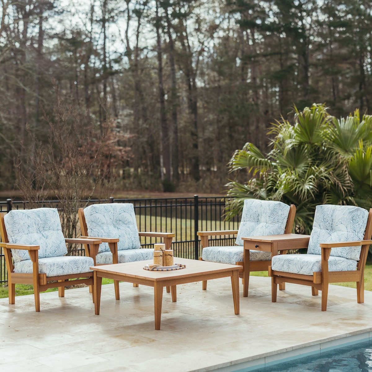 Coastal outdoor living space with low maintenance patio furniture.