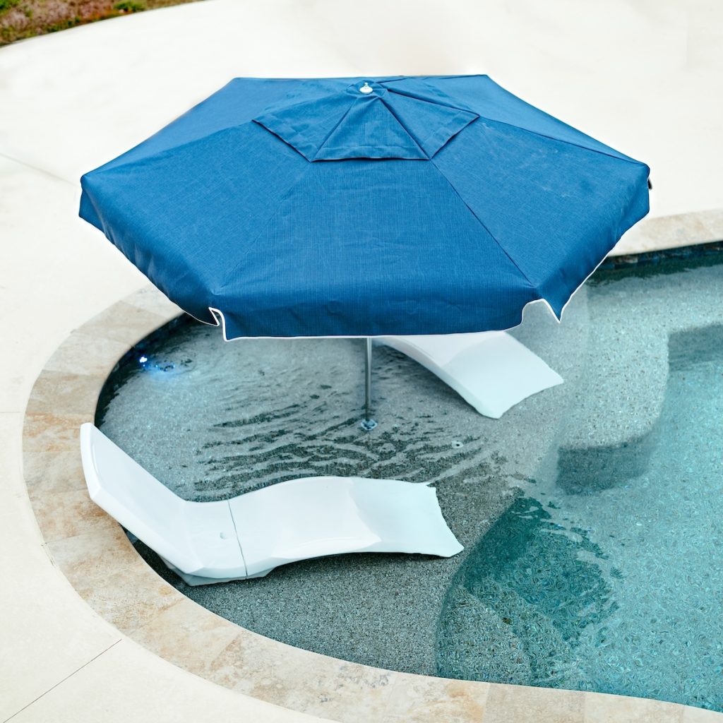 Poolside outdoor furniture and umbrella for a comfortable lounging area