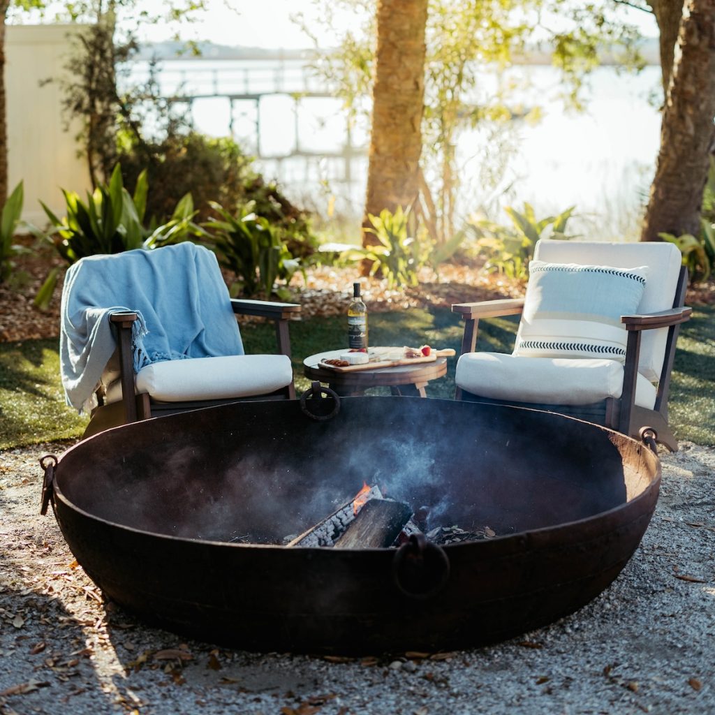 Oasis outdoor lounge furniture beside a fire pit in the fall.